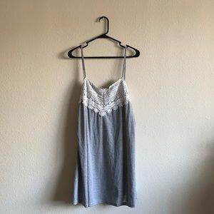 Grey dress with white lace detail.